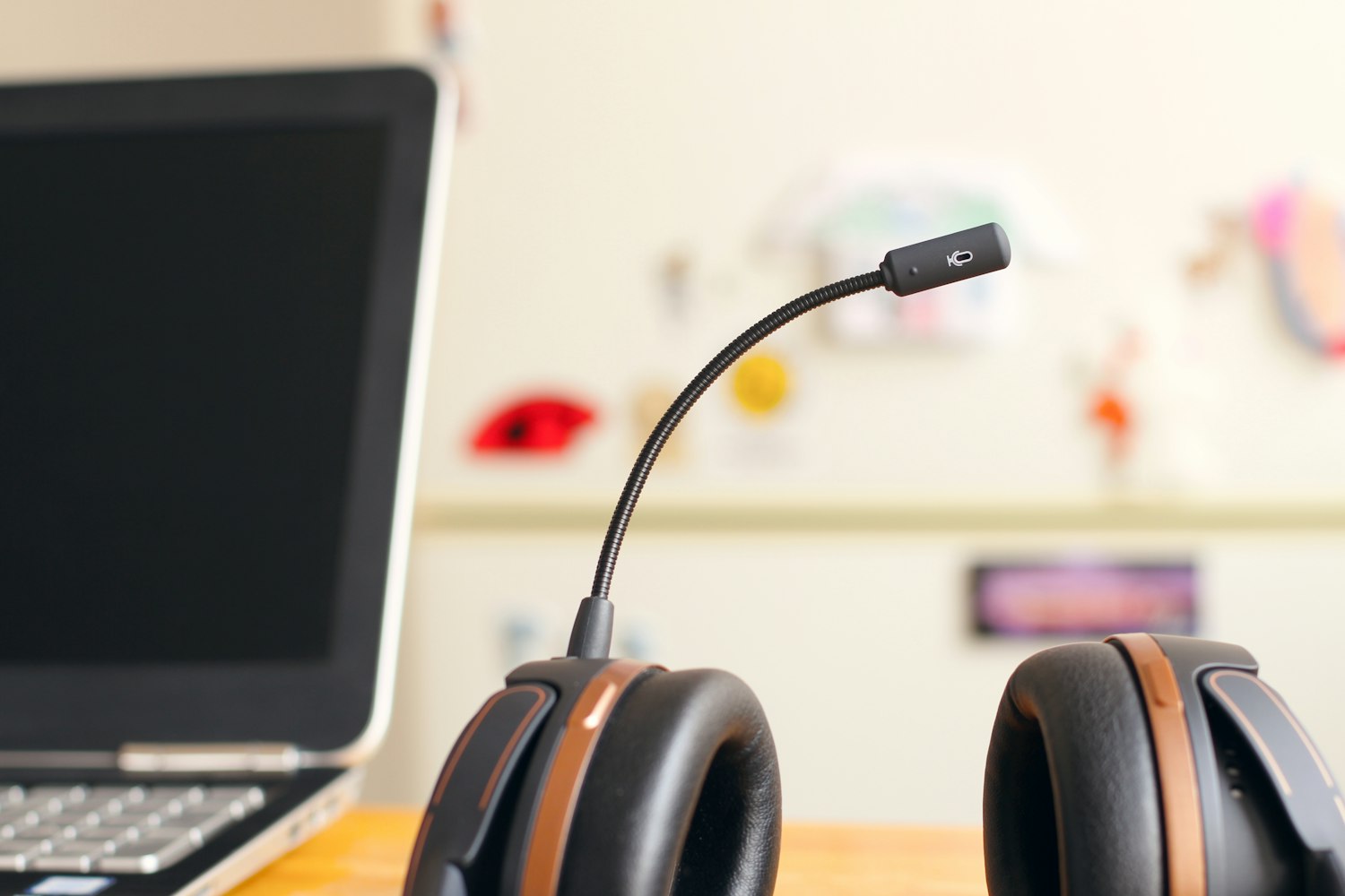 A headset beside a laptop, ready to take the call