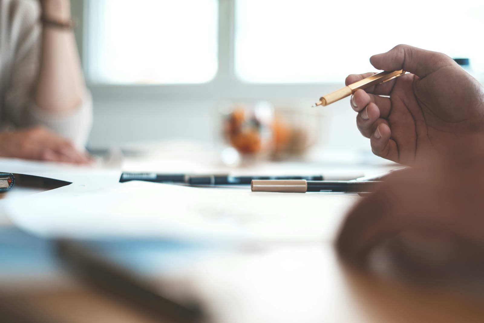 A consultant and client going through documents at a table