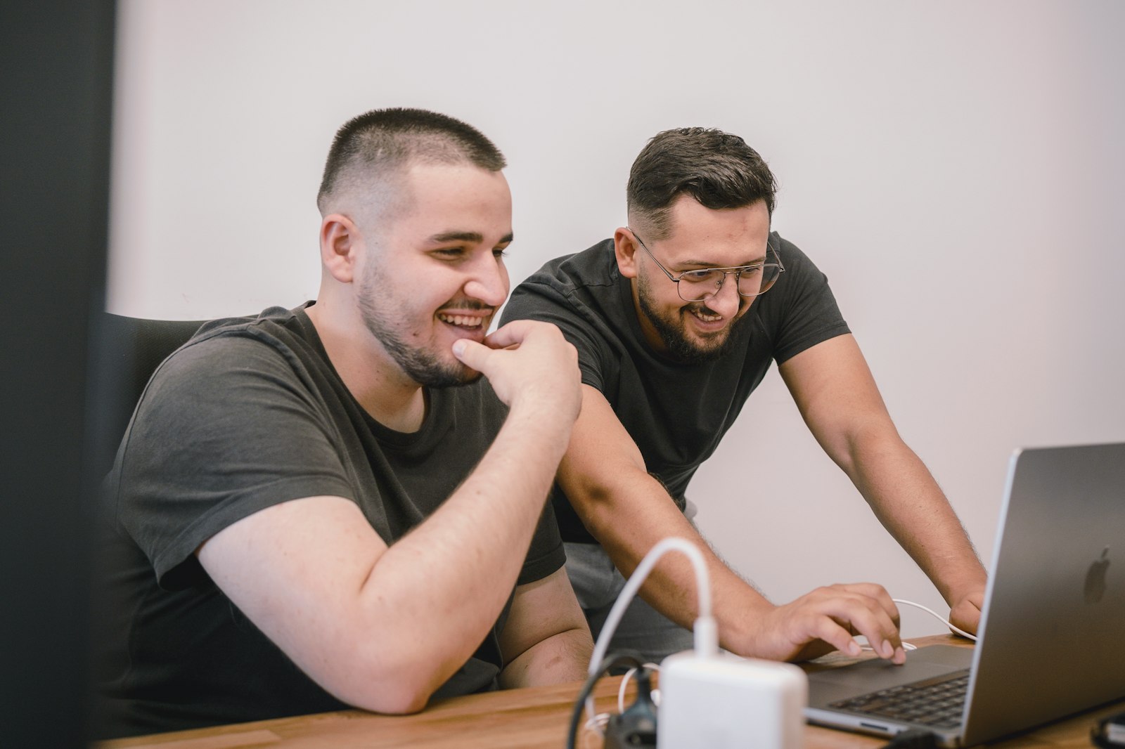 Two colleagues going through a build on a laptop