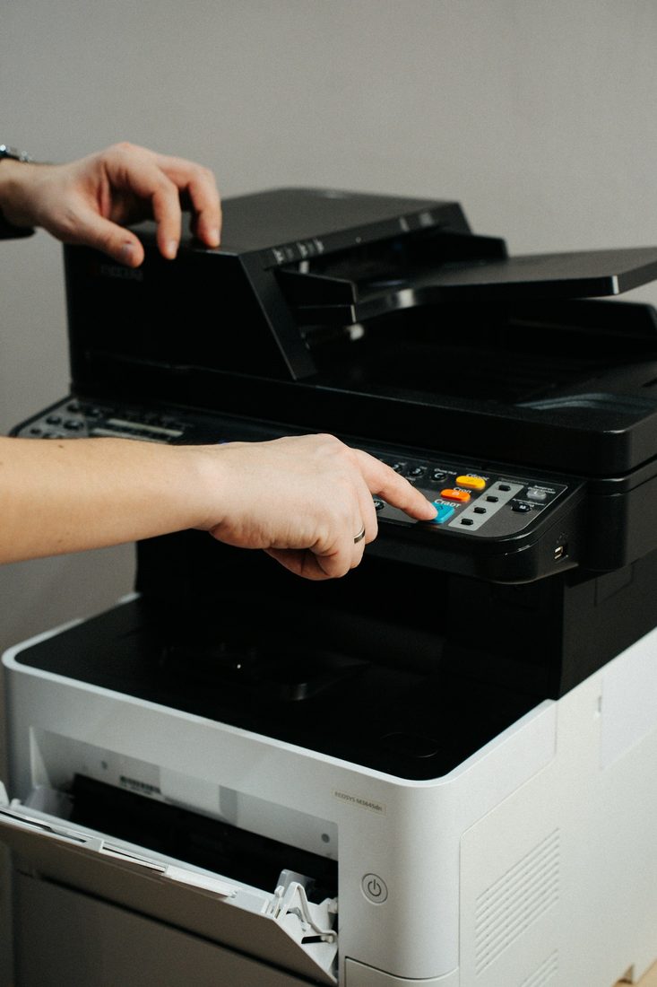 Someone using the control panel of a printer