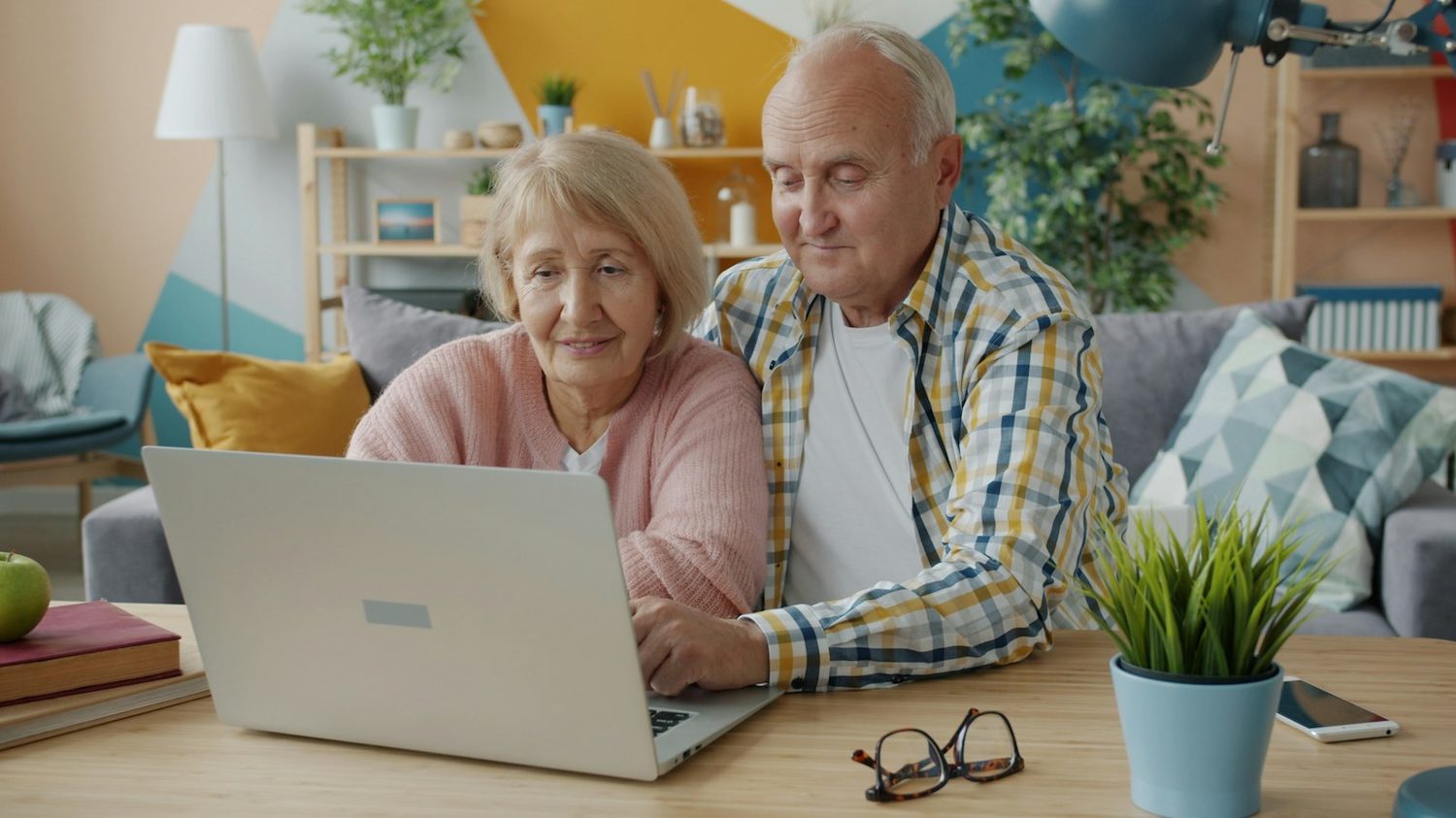 An older couple using a laptop together