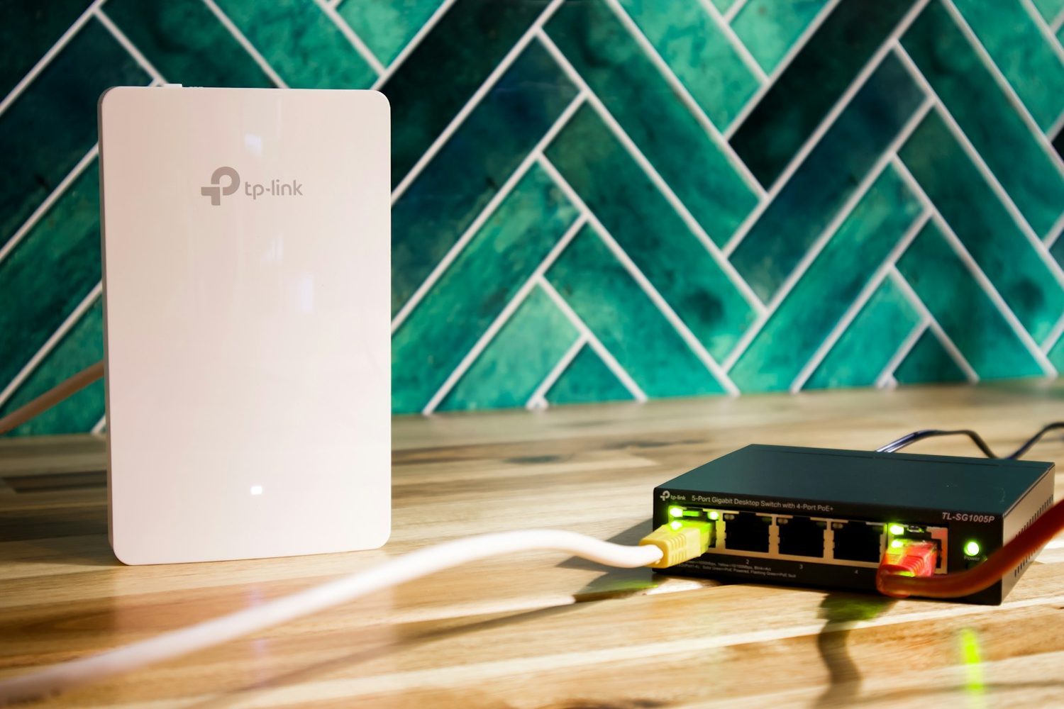 A router and Wi-Fi extender set up on a desk