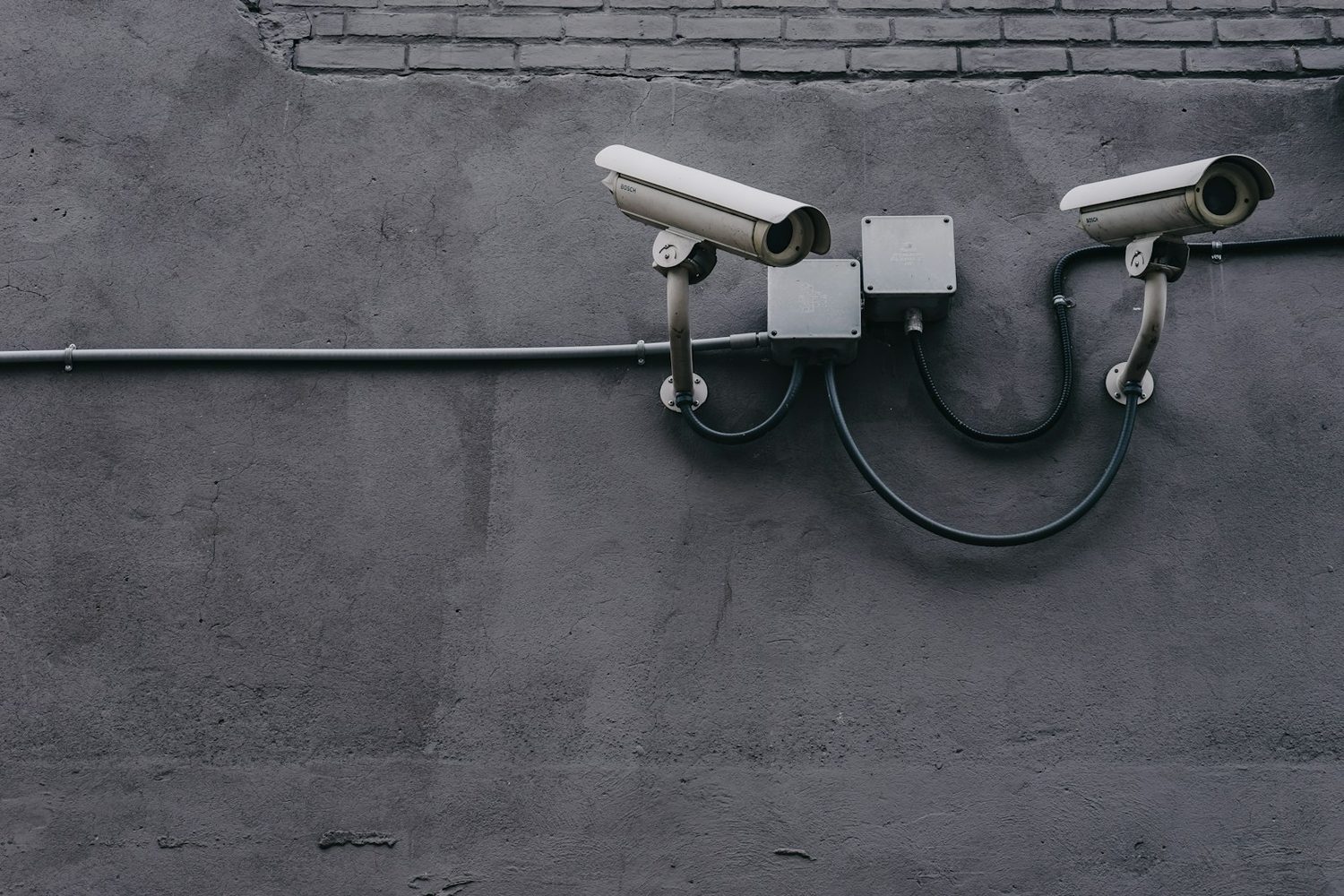 Two CCTV cameras mounted on an exterior wall