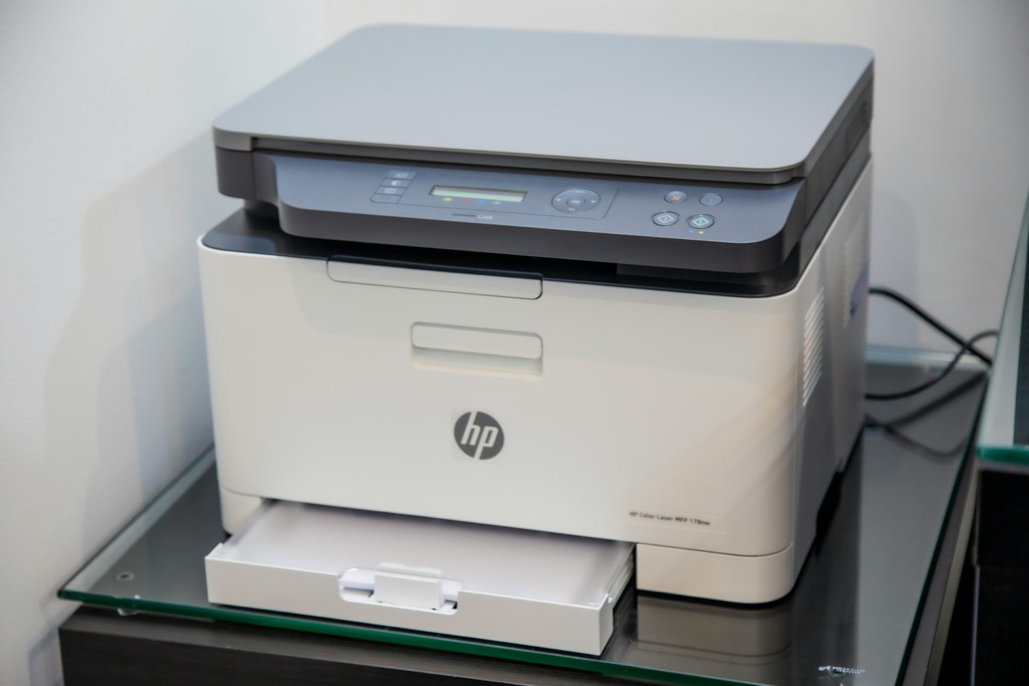 A home office printer set up on a shelf