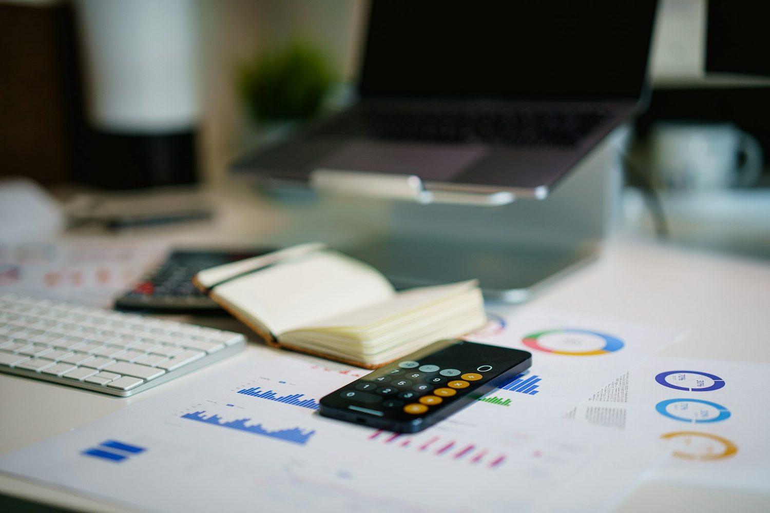 Financial charts and a calculator on a desk