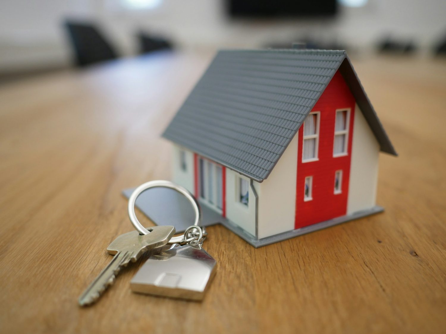 House keys beside a model home on a desk